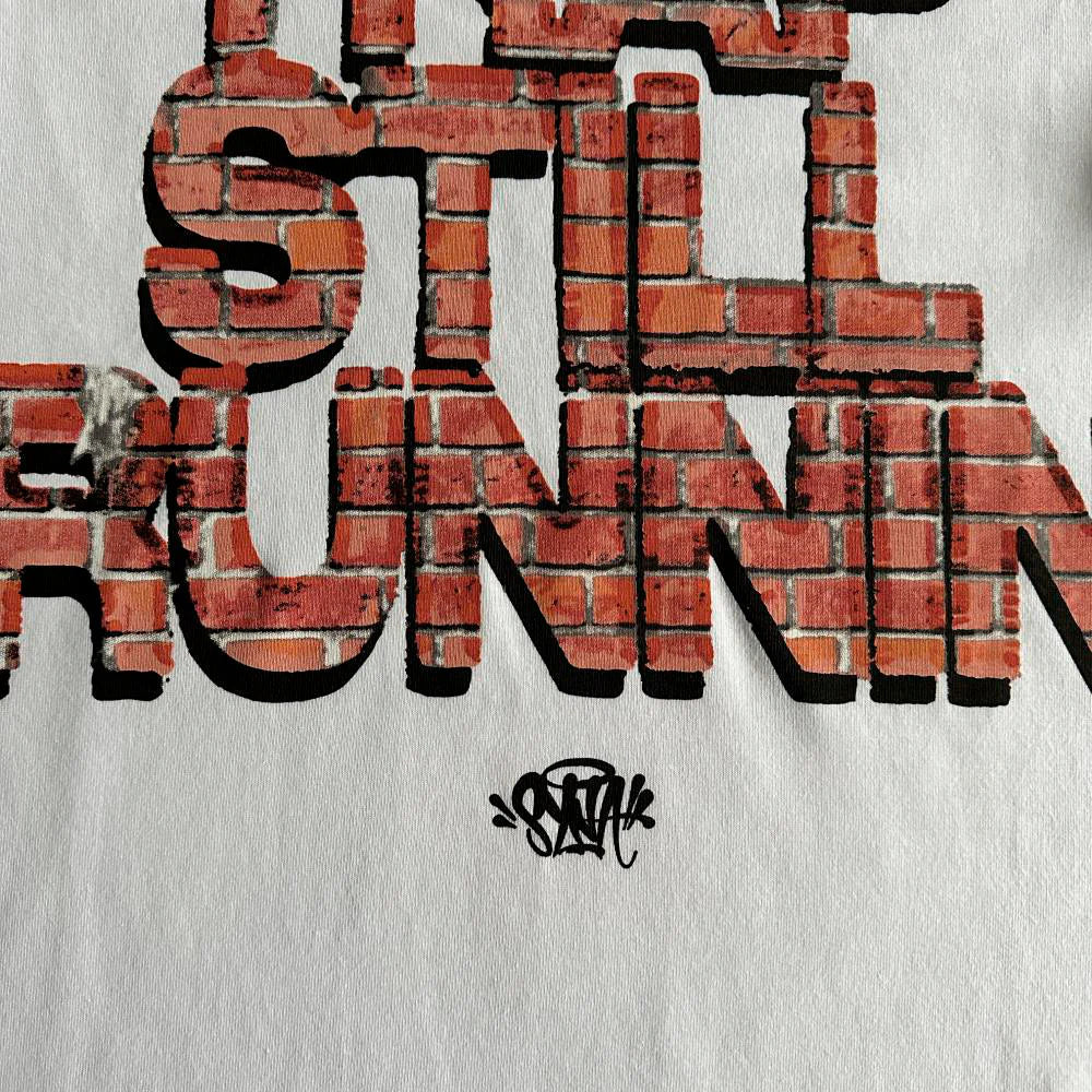 SYNA TRAP STILL RUNNIN TEE